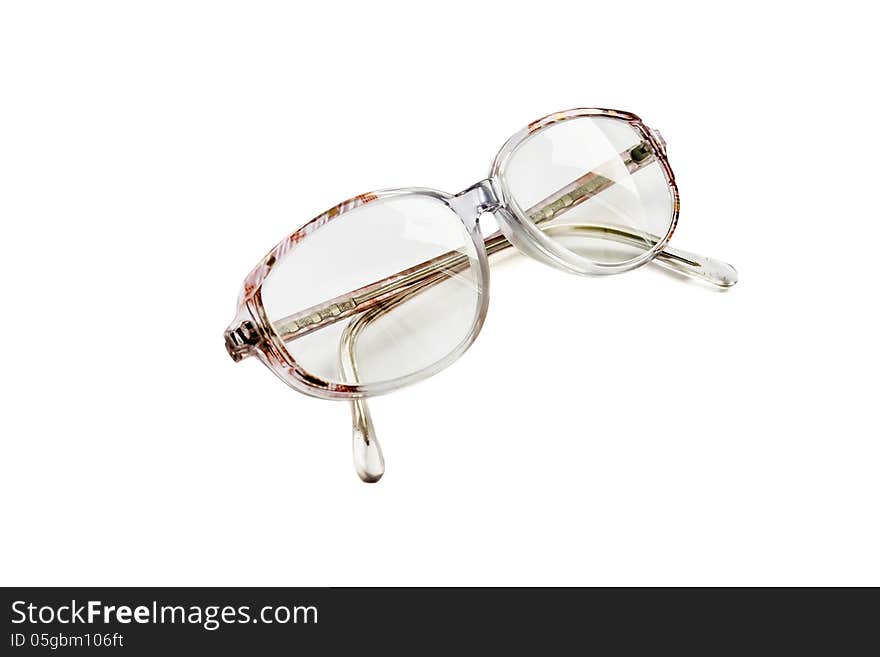 Vintage eyeglasses in a pink frame isolated over white