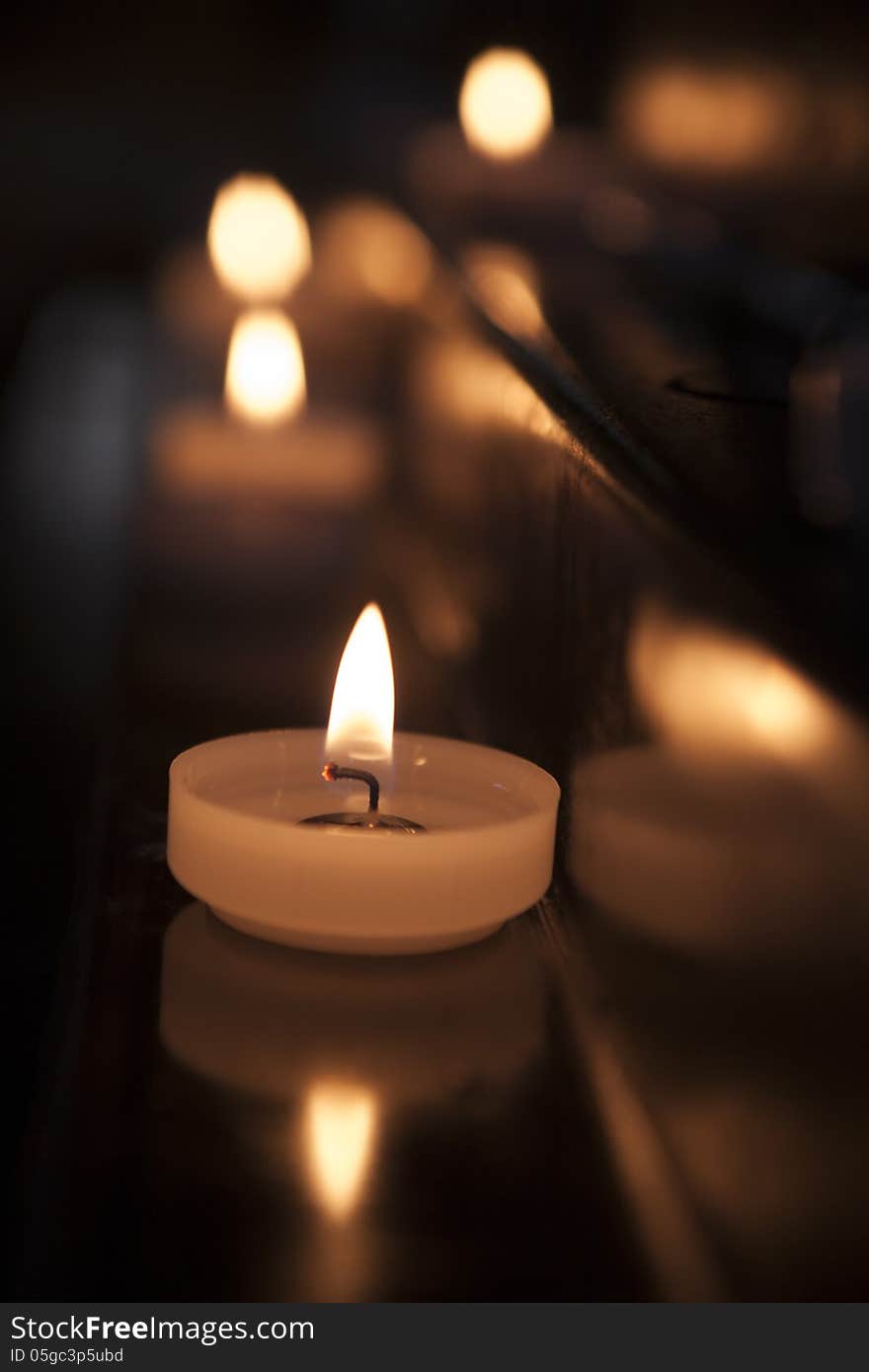 Prayer candles lit in a church. Prayer candles lit in a church