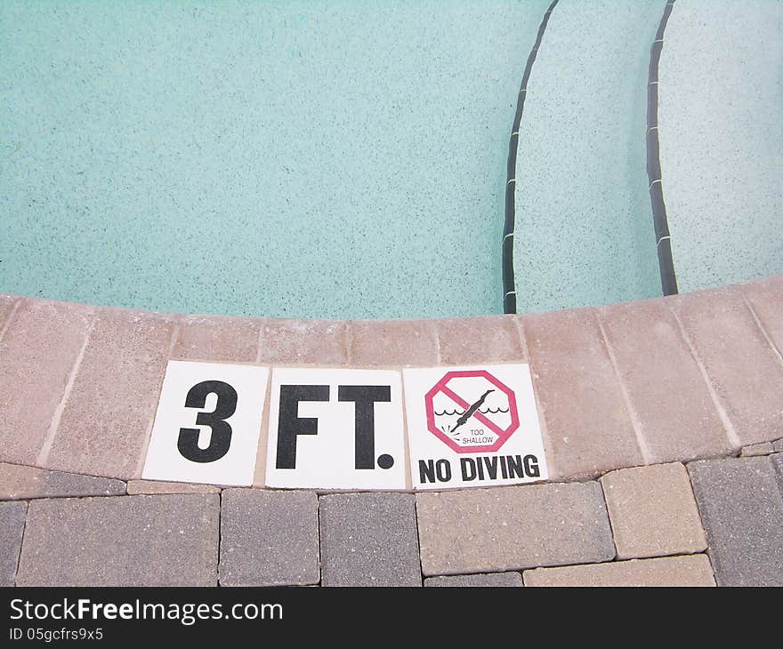 Shallow area of a pool. No Diving Sign.