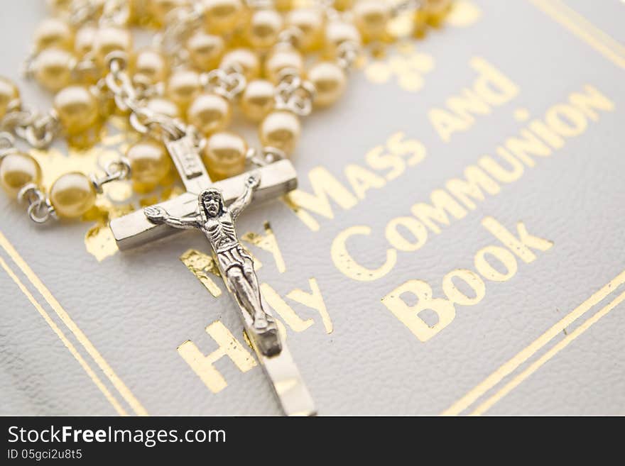 Closeup of a rosary on communion book. Closeup of a rosary on communion book.