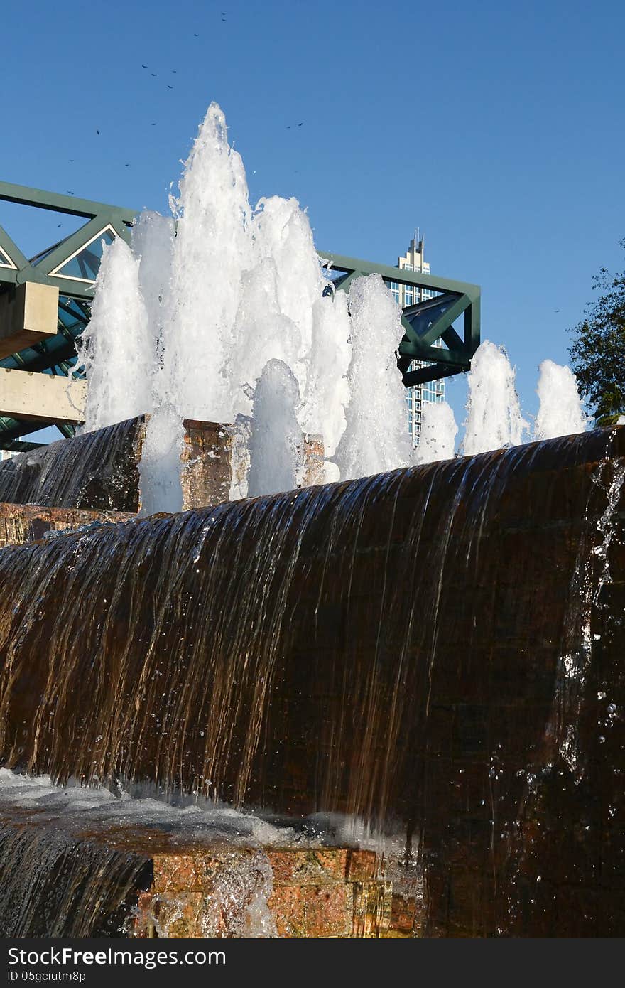 Angled view of a water fountain with blue sky.