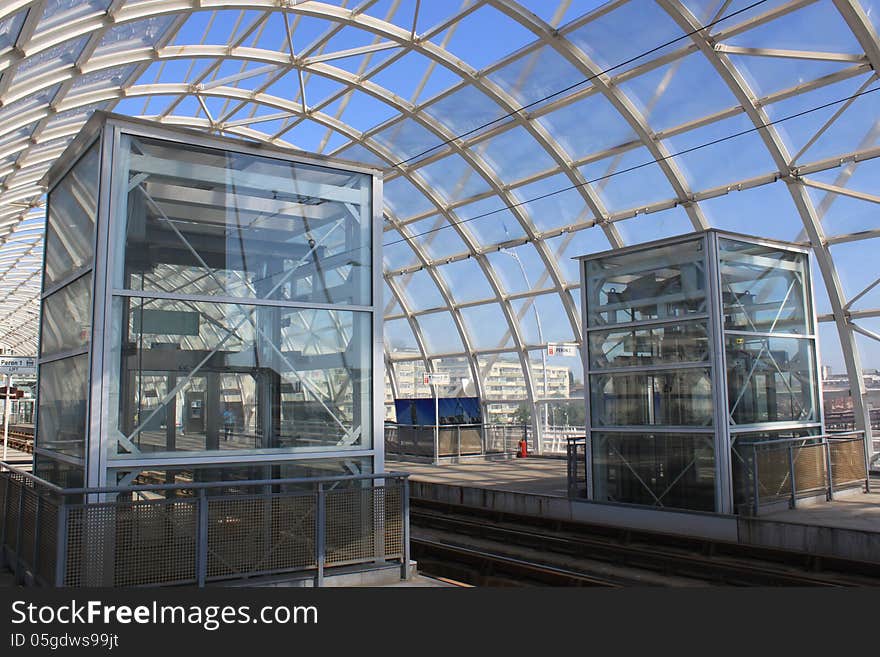 Modern tram station covered with elevators in each direction for people