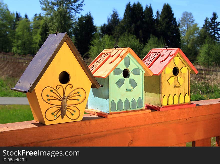 Collection of colorful wooden birdhouses.