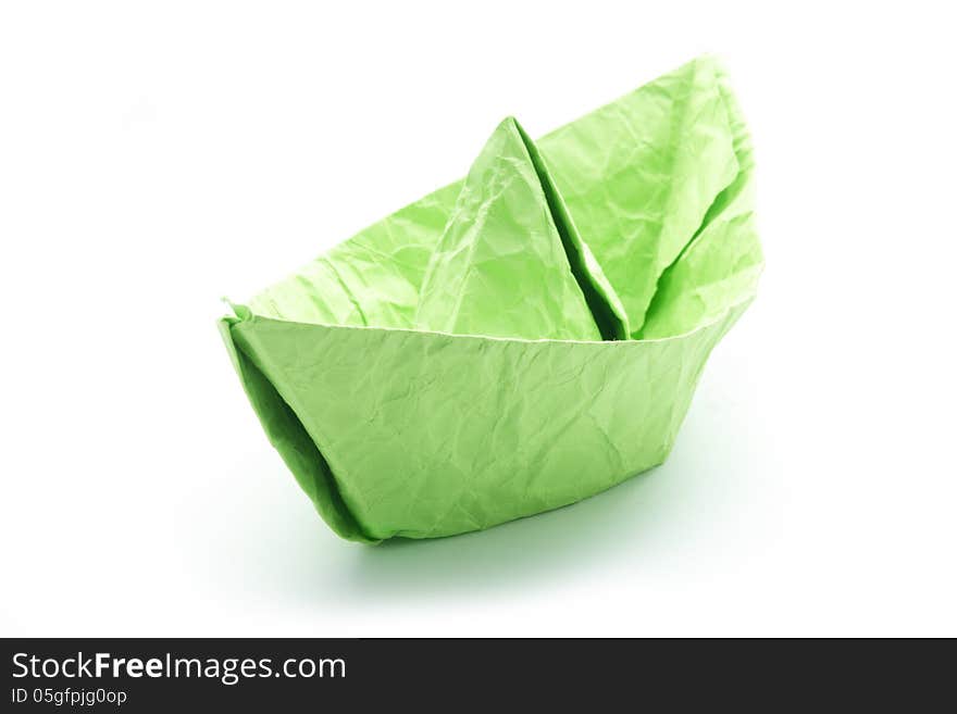 Green crumpled paper origami boat isolated on white. Green crumpled paper origami boat isolated on white