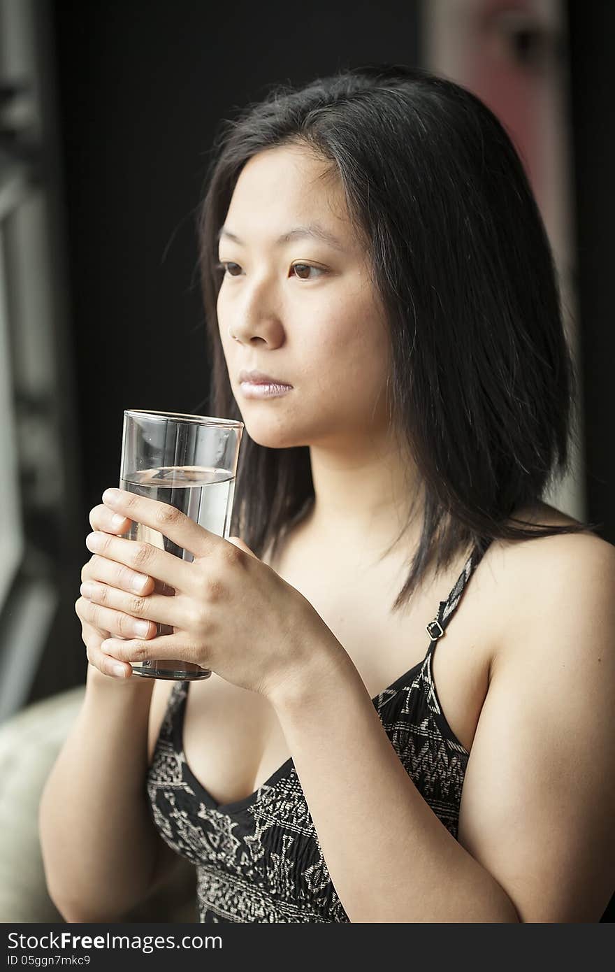 Beautiful Young Woman With Brown Hair And Eyes Drinking Water