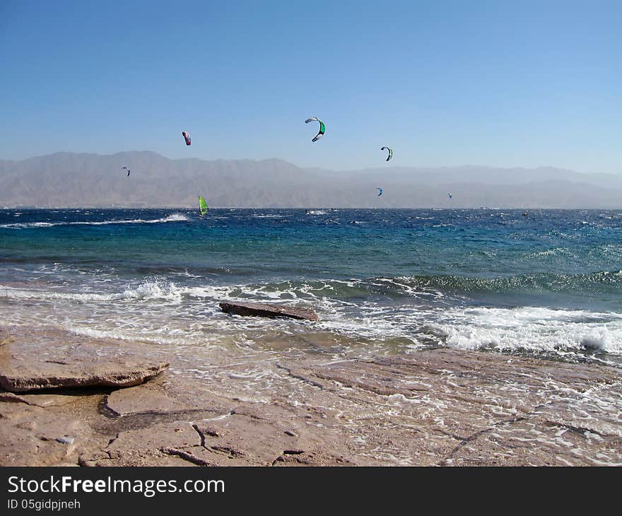 Windsurfers and kites on the beach of Red Sea, Eilat, Israel. Windsurfers and kites on the beach of Red Sea, Eilat, Israel