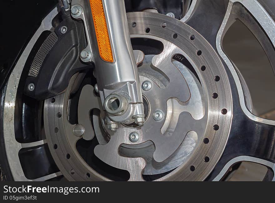 Closeup detail of a motorcycle's front brake and wheel. Closeup detail of a motorcycle's front brake and wheel