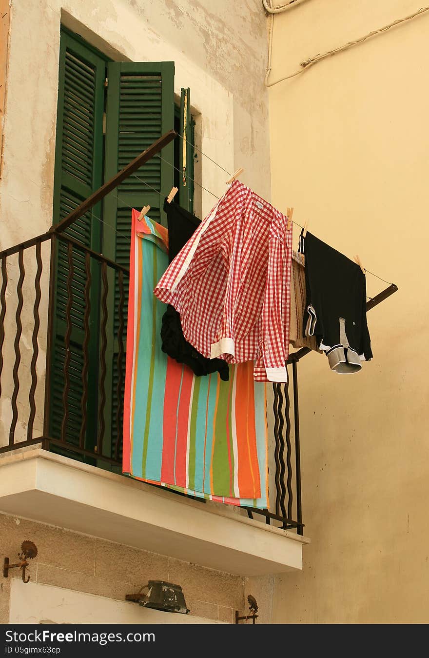 Italian balcony with hanging clothes