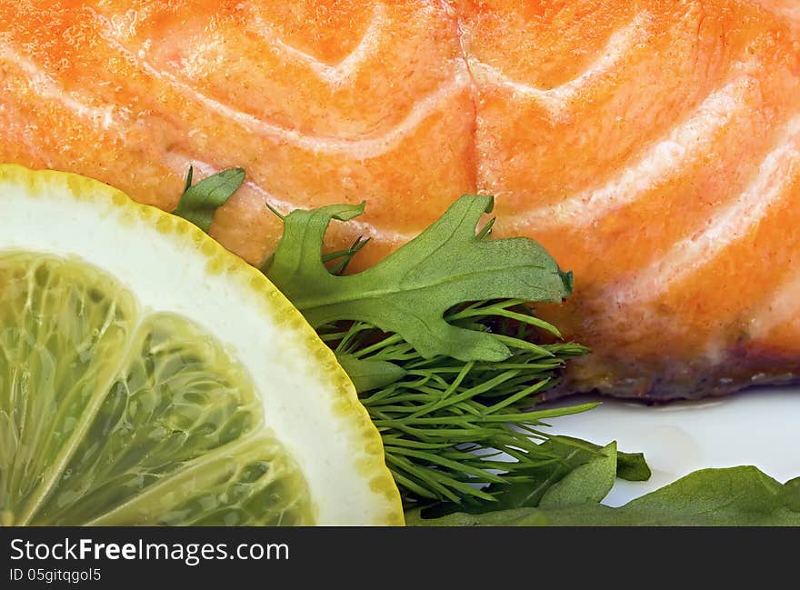 Сlose-up of salmon with lemon and lettuce