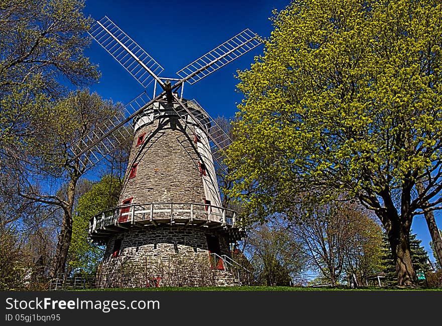 Old windmill amongst trees in spring