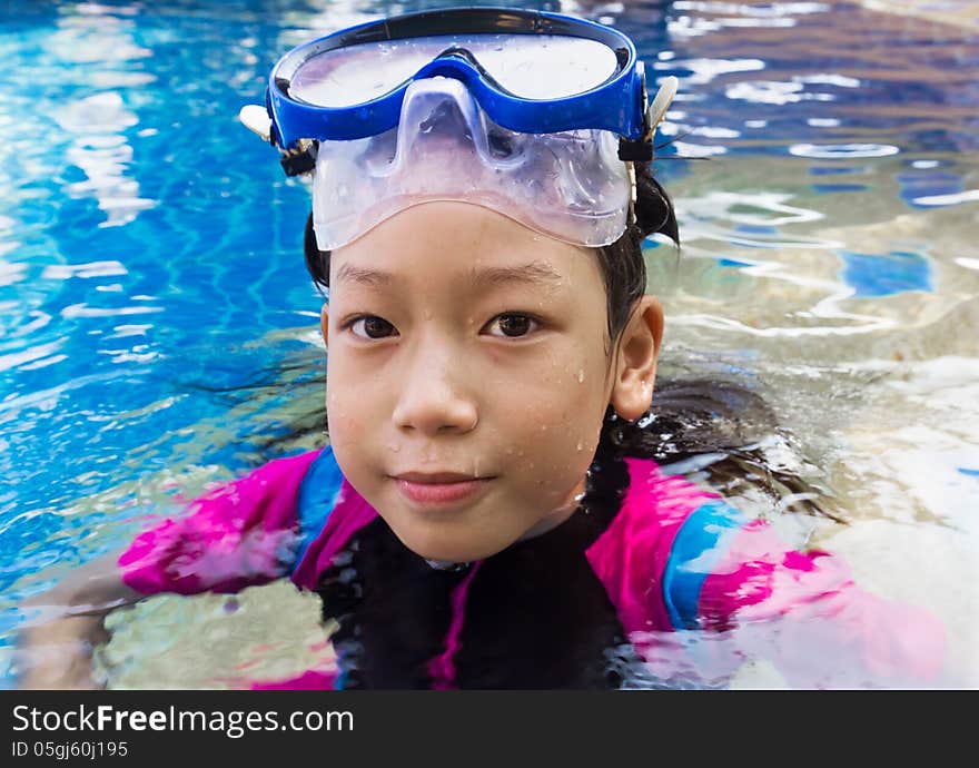 Girl relaxing on the side of a swimming pool. Girl relaxing on the side of a swimming pool