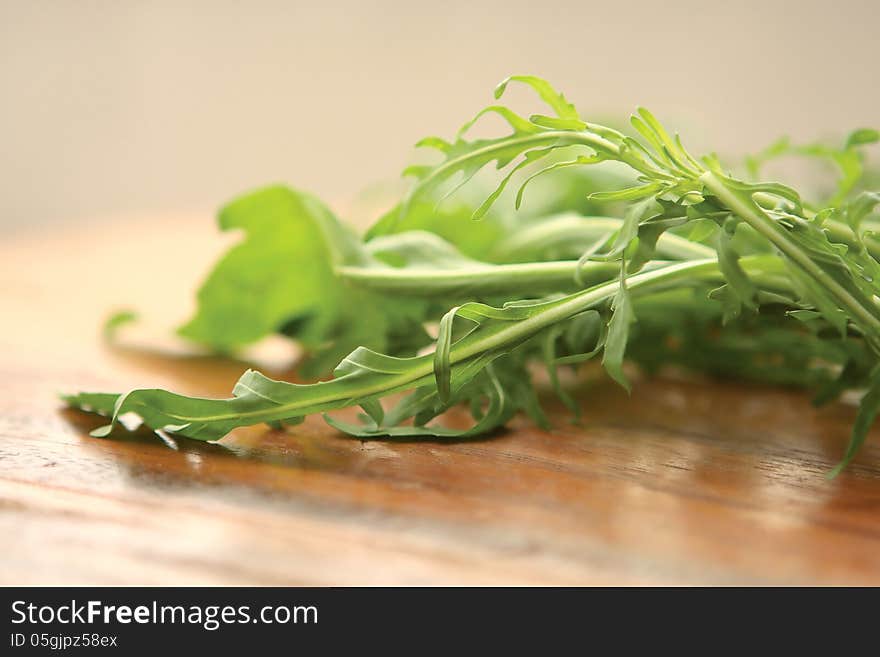 Fresh Green Rucola on a wooden board