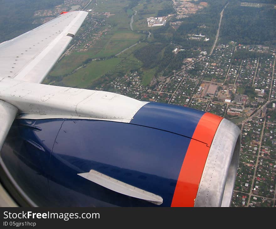 View of the city from the top of the airplane on summer day