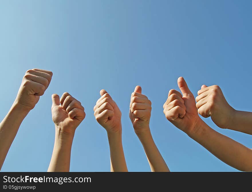 A sign of a thumbs up on a blue sky background. A sign of a thumbs up on a blue sky background.