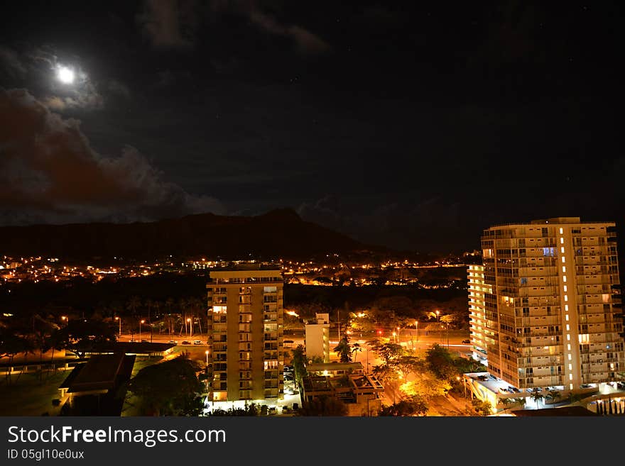 A moonlit diamond head in the background of the East Side of Waikiki.