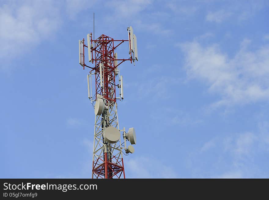 Telecommunication tower with antennas on a blue sky background. Telecommunication tower with antennas on a blue sky background