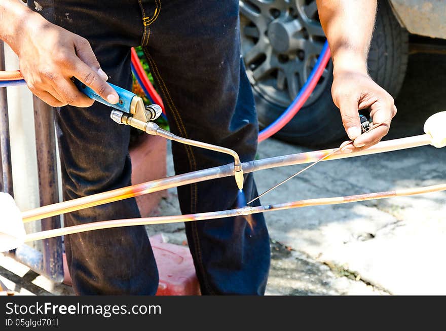 Welder using torch on metal object. Welder using torch on metal object