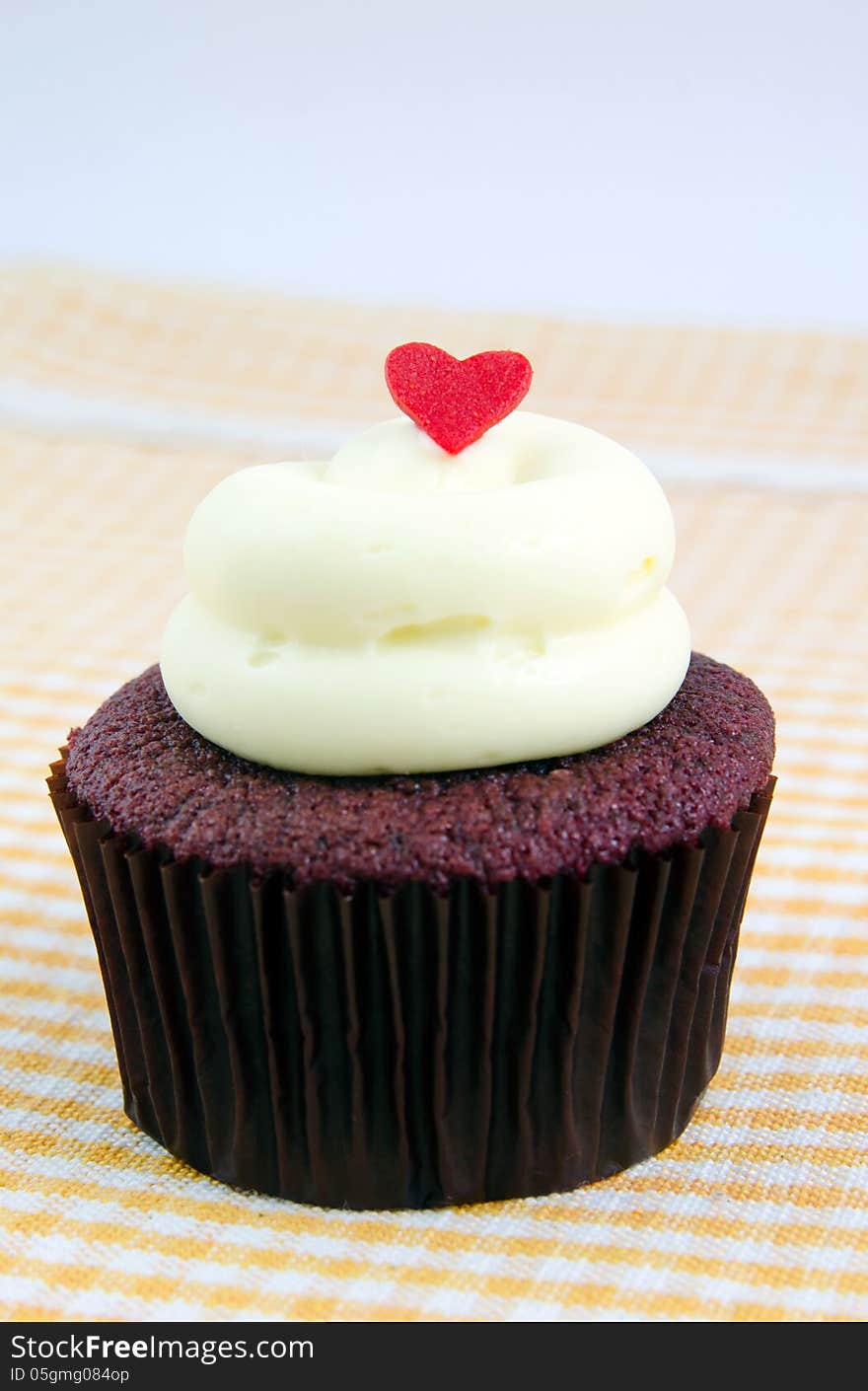 Fanciful cupcake with cream cheese and heart. Fanciful cupcake with cream cheese and heart