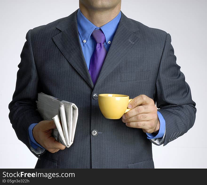 Businessman holding a cup of coffee and news paper. Businessman holding a cup of coffee and news paper.