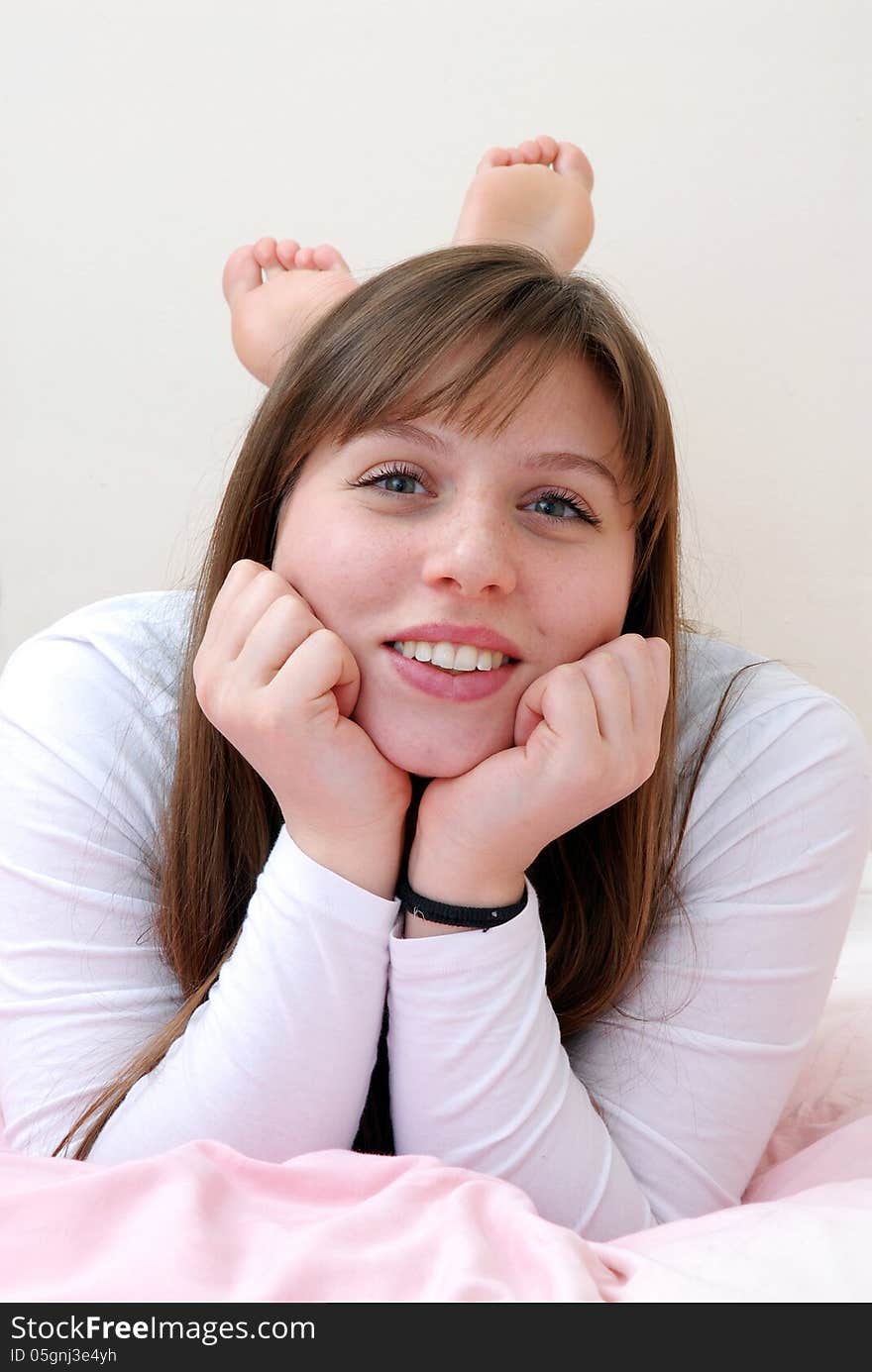 Beautiful young woman portrait lying down on bed. Beautiful young woman portrait lying down on bed.