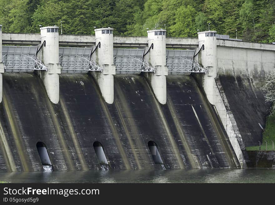 Energy producing power station on a dam at a lake. Energy producing power station on a dam at a lake