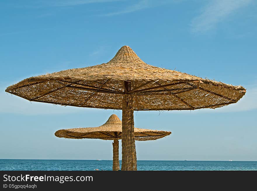 Two parasols at the sea beach