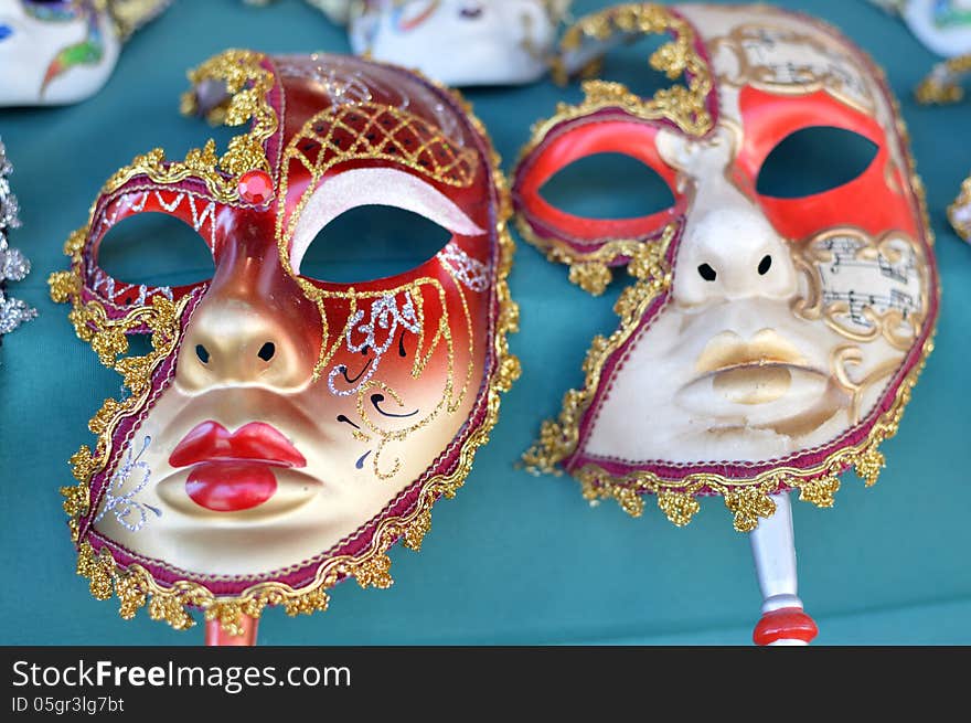 two carnival masks with the blue background