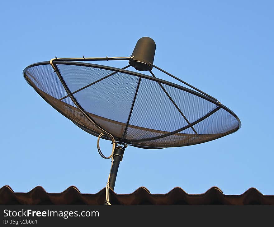 Black satellite dish on roof in sunlight. Black satellite dish on roof in sunlight