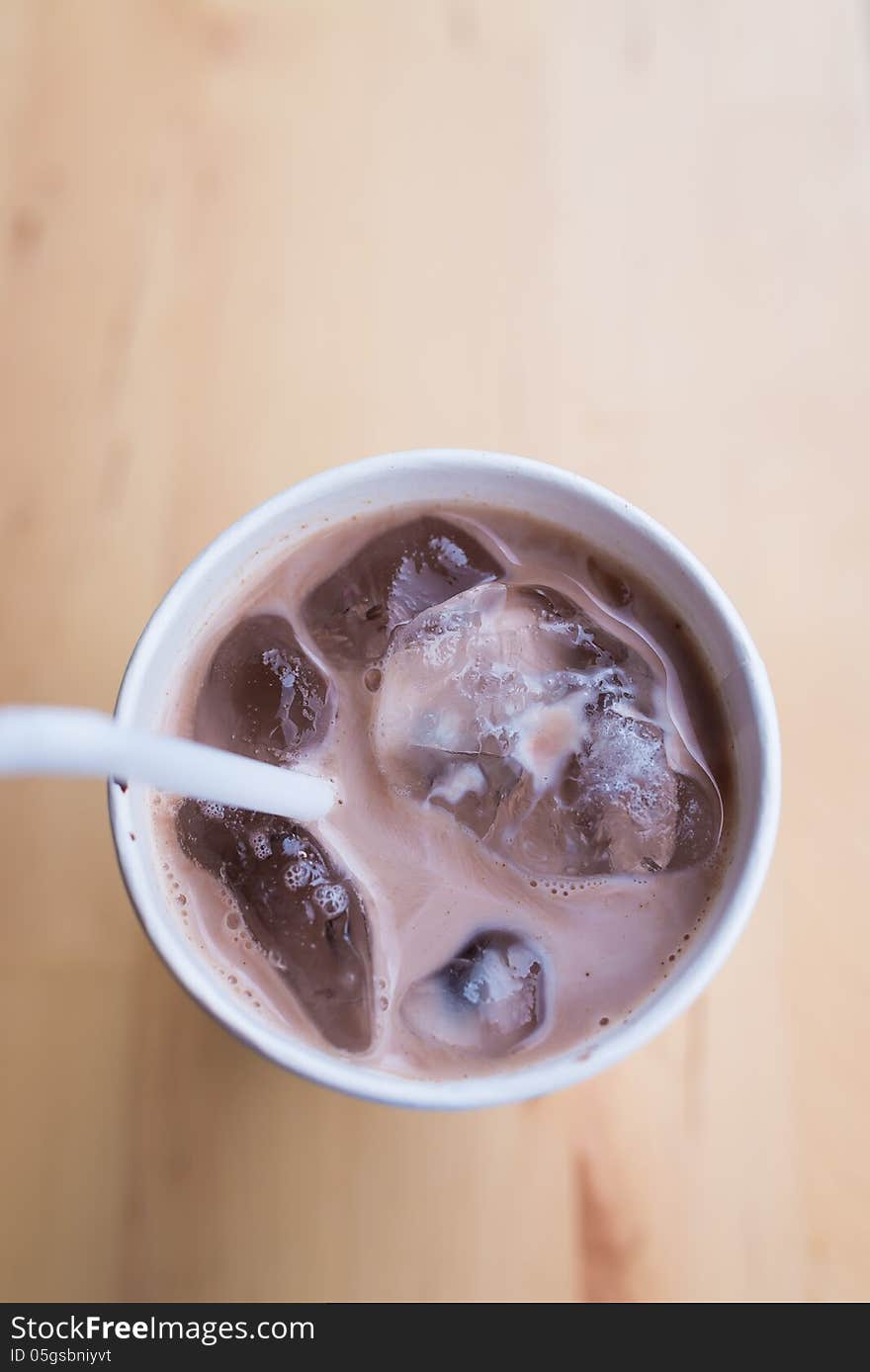 White paper cup of coffee with white straw