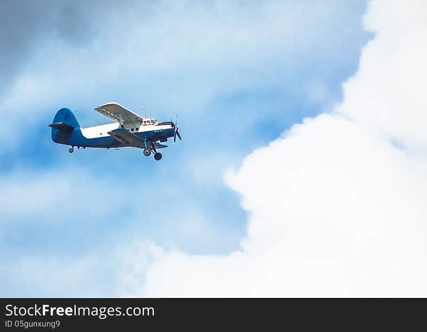 Biplane In Blue Sky Over Clouds. Biplane In Blue Sky Over Clouds