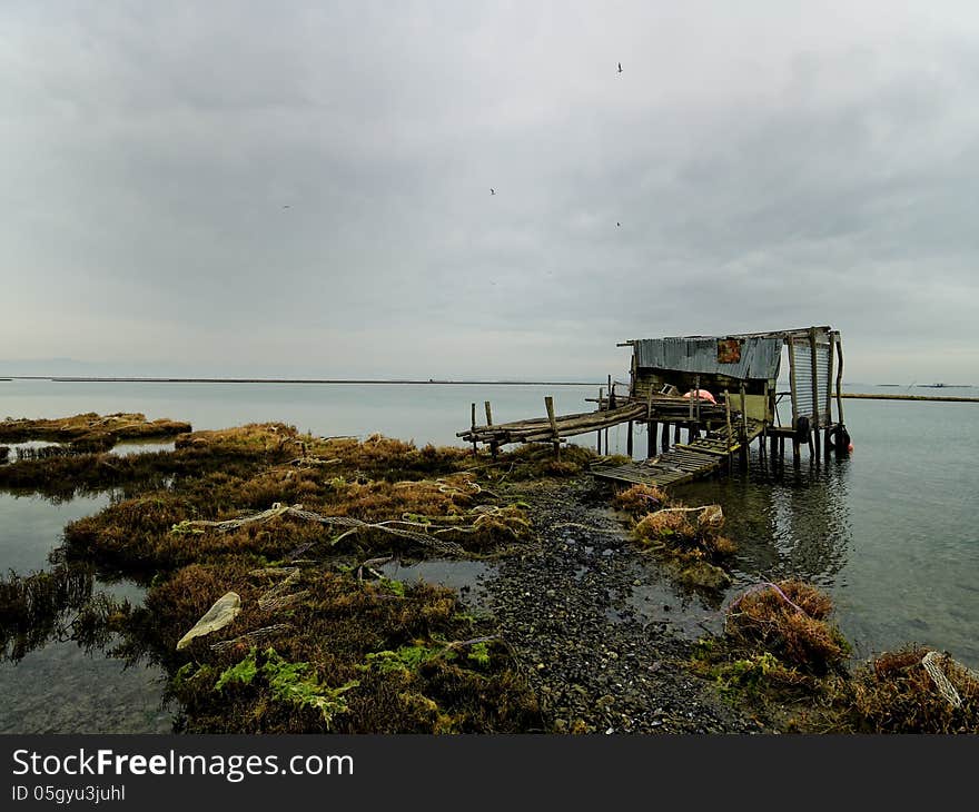 Fisherma's hut with reflection in still waters, Greece Axios outfall. Fisherma's hut with reflection in still waters, Greece Axios outfall