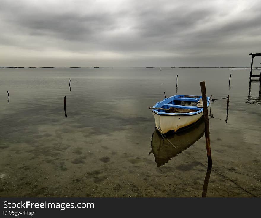 Moored boat with reflection in still waters, Greece Axios outfall. Moored boat with reflection in still waters, Greece Axios outfall