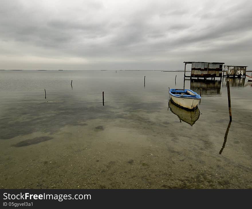 Moored boat with reflection in still waters, Greece Axios outfall. Moored boat with reflection in still waters, Greece Axios outfall