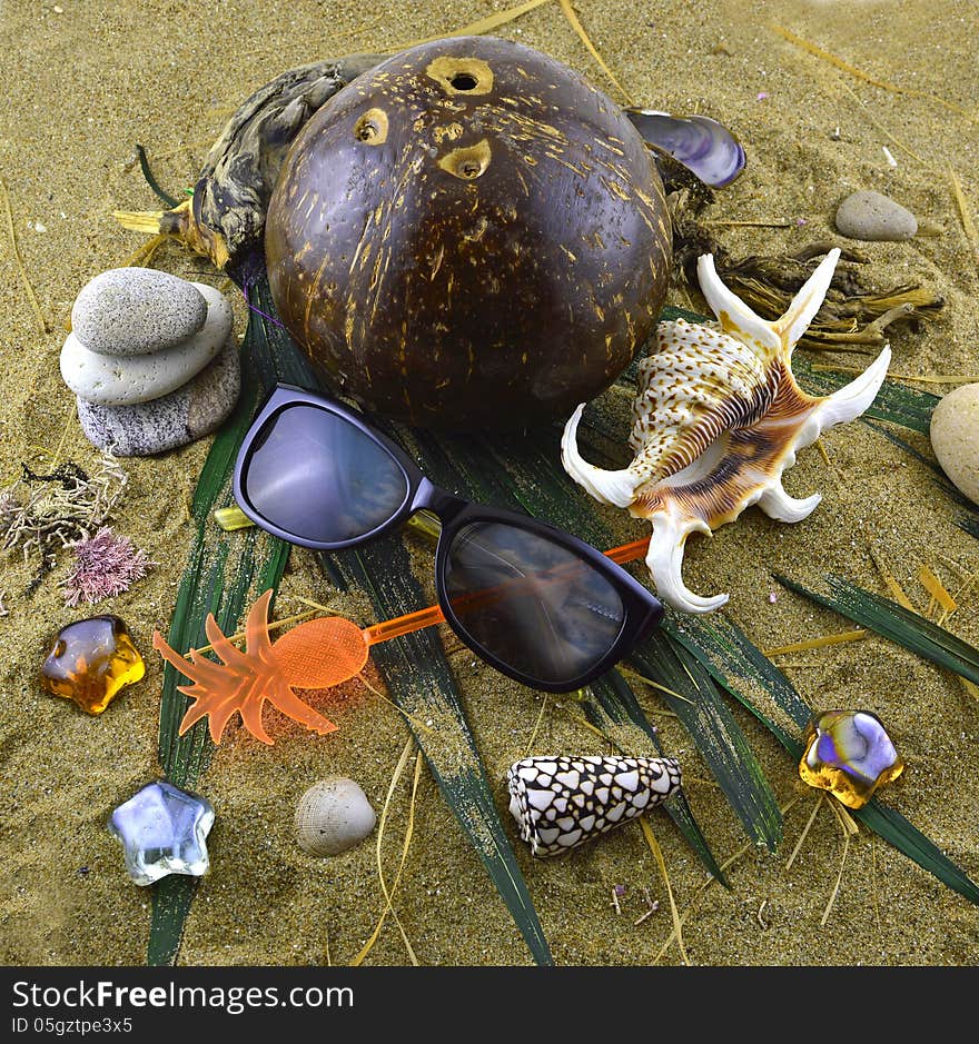 Still life of sunglasses and nautical objects on the sand. Still life of sunglasses and nautical objects on the sand