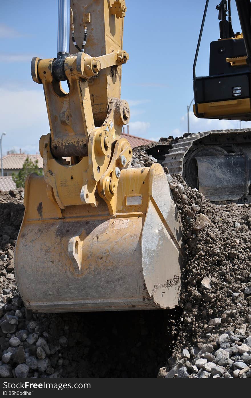 This is a hydraulic excavator with a 2 cubic yard bucket attached, digging in loose soil and rock. This is a hydraulic excavator with a 2 cubic yard bucket attached, digging in loose soil and rock.