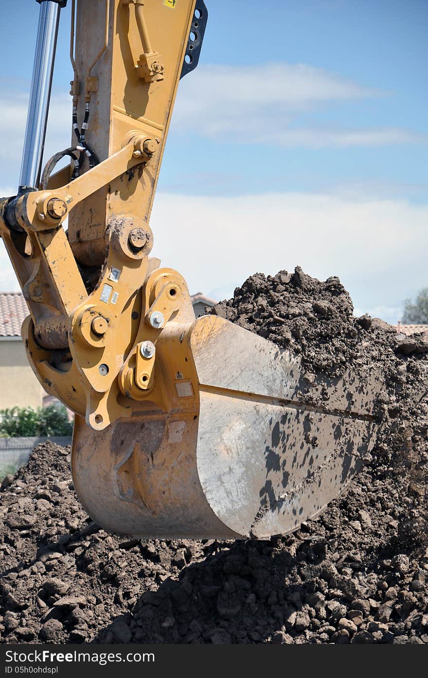 This is a hydraulic excavator with a 2 cubic yard bucket attached, digging in loose soil and rock. This is a hydraulic excavator with a 2 cubic yard bucket attached, digging in loose soil and rock.