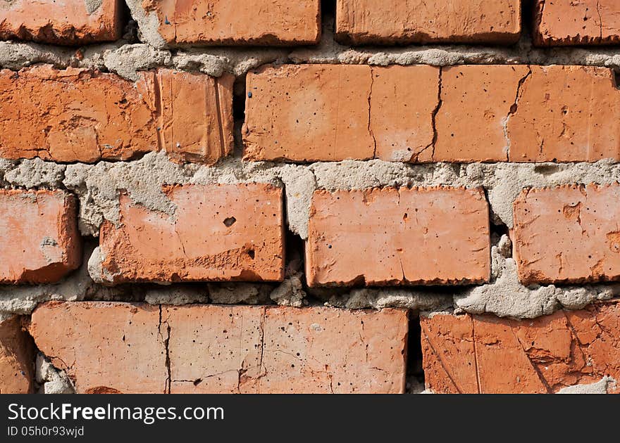 Weathered old red brick wall. Weathered old red brick wall