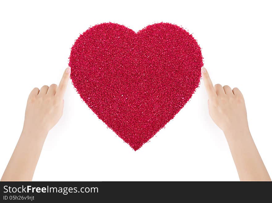 Woman's hands making the heart of red sand by index fingers on white background. Woman's hands making the heart of red sand by index fingers on white background.