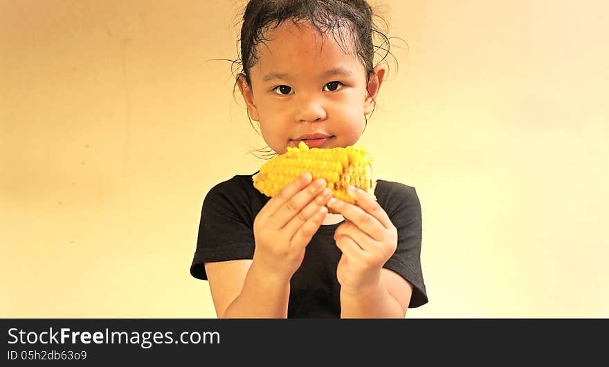 Little girl hold a corn. Little girl hold a corn.