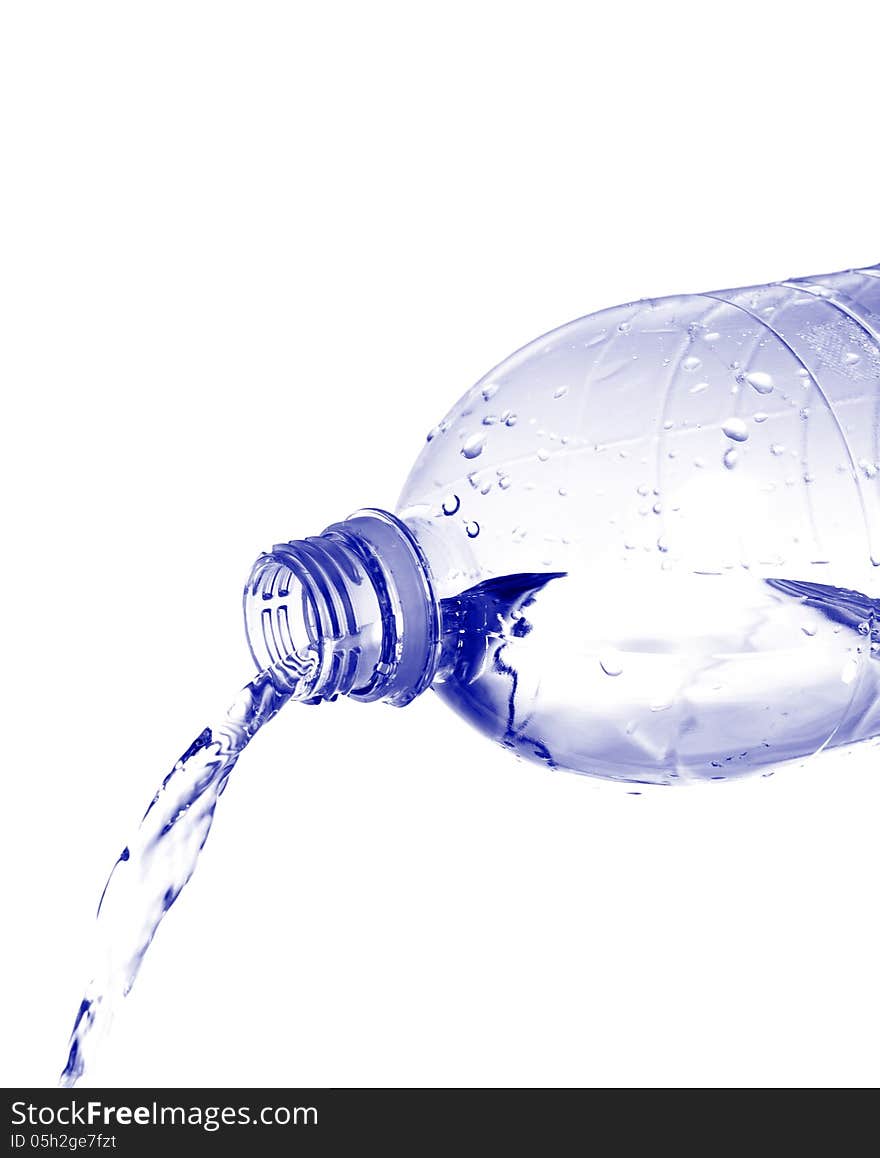 Water pours from a plastic bottle isolated on white background. Water pours from a plastic bottle isolated on white background