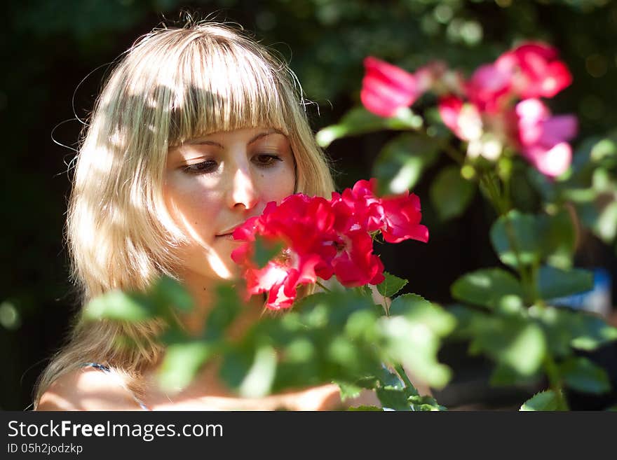 Young woman with red flowers on a walk