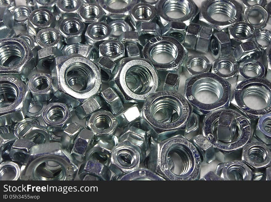 The photograph shows metal bolts arranged on a white background. The photograph shows metal bolts arranged on a white background.