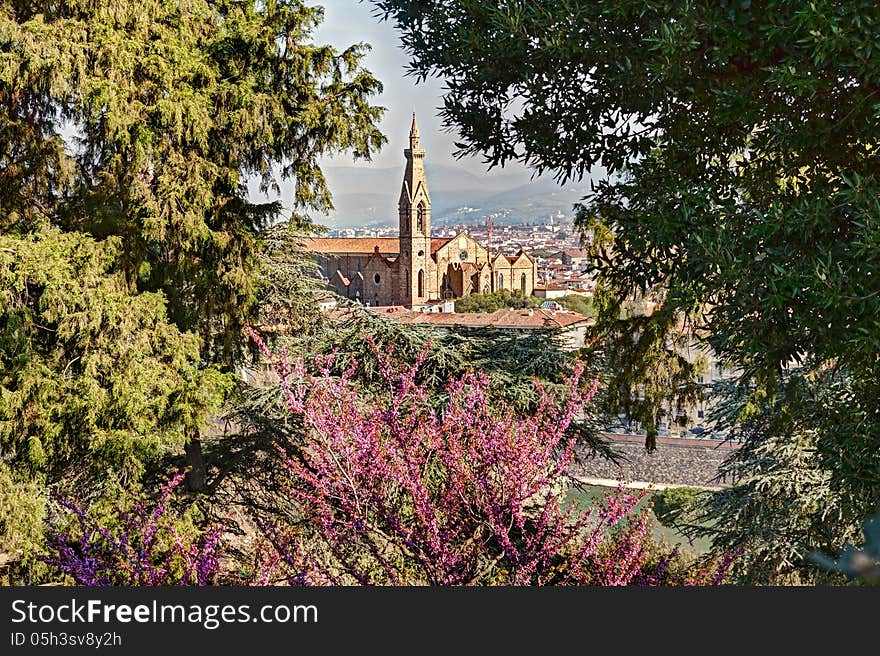 View of the famous cathedral Basilica di Santa Croce in Florence, Italy, at spring, framed with green leaves and flowers. View of the famous cathedral Basilica di Santa Croce in Florence, Italy, at spring, framed with green leaves and flowers