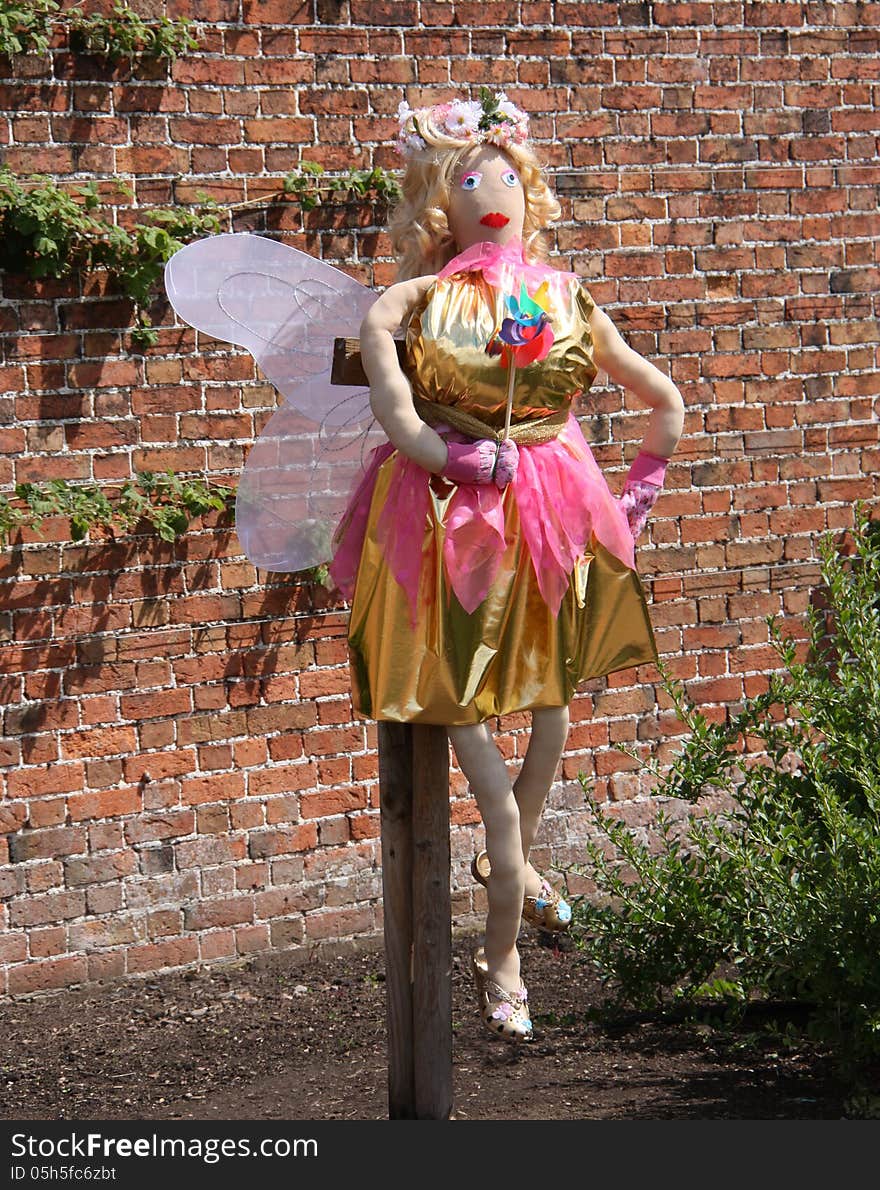 A Brightly Coloured Fairy Scarecrow in a Garden. A Brightly Coloured Fairy Scarecrow in a Garden.