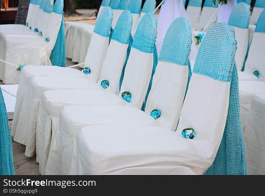 Closeup of wedding chair, decorated with blue ribbon. Closeup of wedding chair, decorated with blue ribbon.