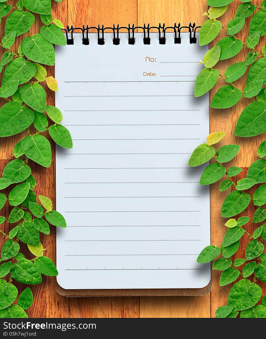 Blank Planning Notebook On Wood Background With Ivy Fixing Tree.