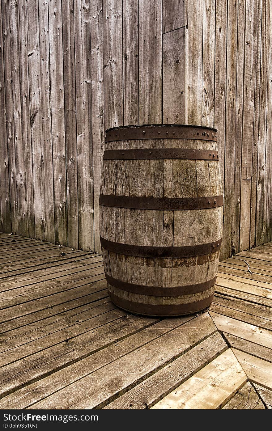 Old wood barrel on a wooden gallery and a wooden house