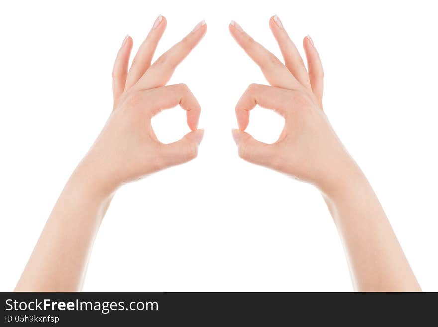 Woman's hands form the mask gesture on a white background. Woman's hands form the mask gesture on a white background.