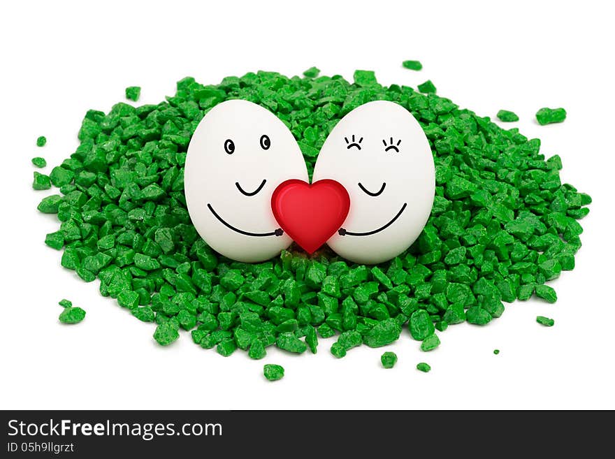 Two eggs on green stones.