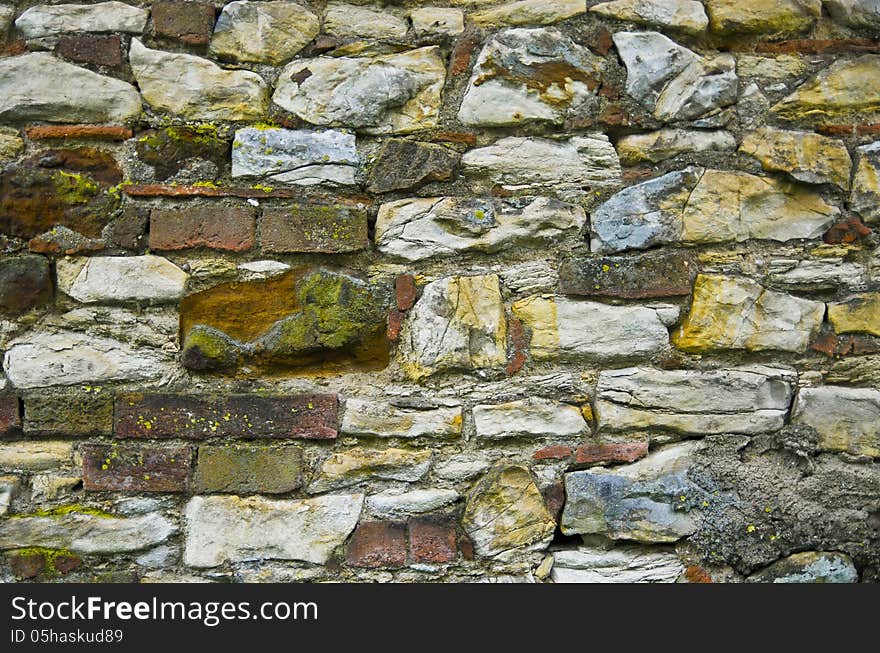 Natural wall full of many stones and bricks